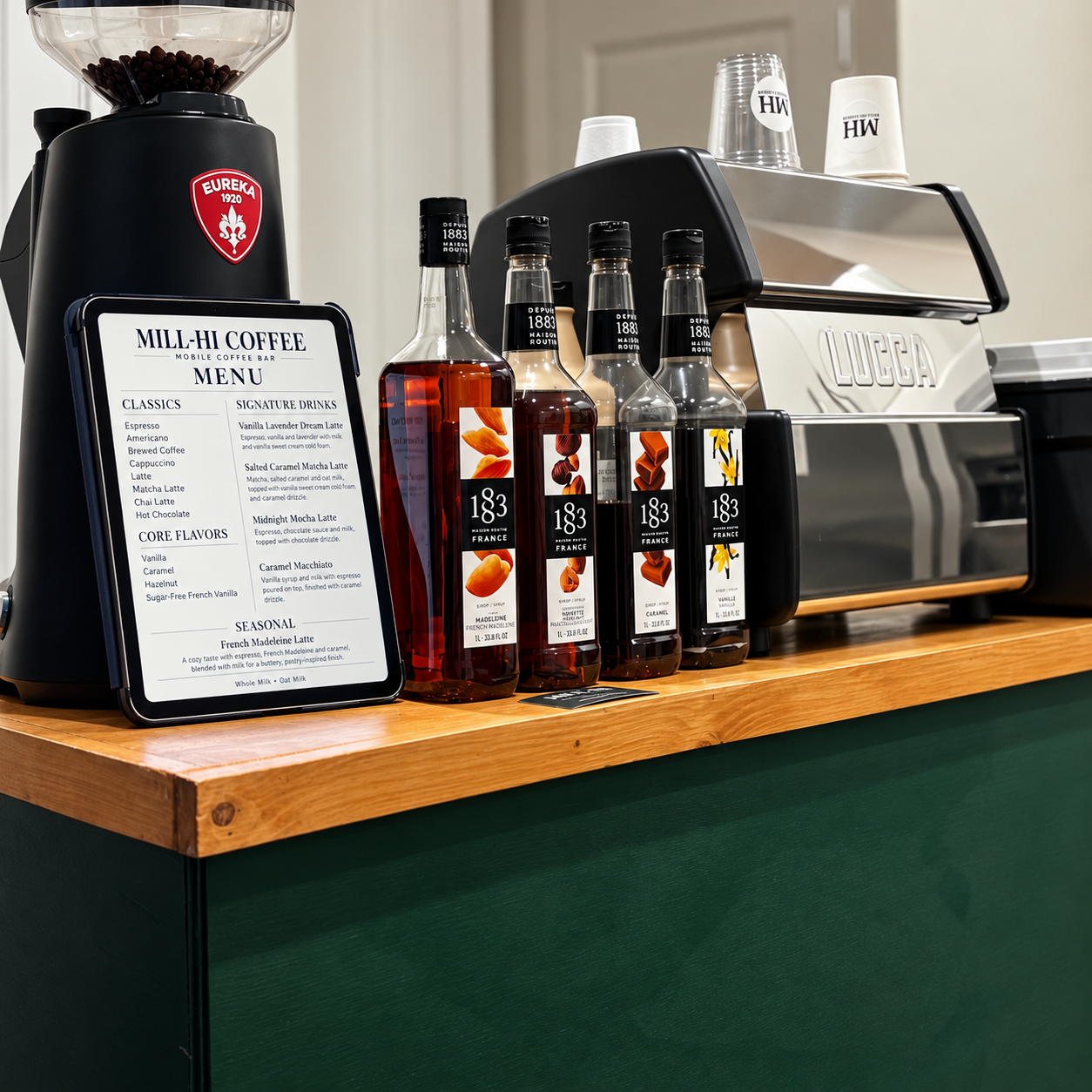 Mill-Hi Coffee's forest-green mobile bar with wood trim, espresso machine, and menu set up indoors